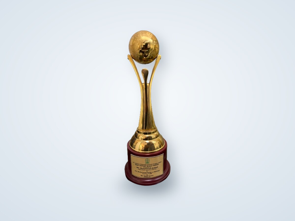 The 5th Lahore Chamber Export Trophy 2022 — a gold globe on a gilded column — engraved 'Best Export Brand Trophy' for Mr. Muhammad Arshad of Sadiq Gelatin Industries.